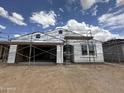 Exterior view of a home under construction showing installed windows and wrapped insulation at 2370 E Spur Dr, San Tan Valley, AZ 85140