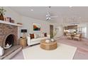 Cozy living room features a brick fireplace, ceiling fan, stylish furnishings, and an open floor plan at 3031 N Civic Center Plz # 112, Scottsdale, AZ 85251