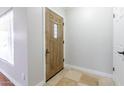 Bright entryway featuring tile floors, a decorative wood door, and white walls at 4713 E Cambridge Ave, Phoenix, AZ 85008