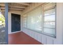 View of the covered front porch with a secure front door, a window, and neutral tones at 4713 E Cambridge Ave, Phoenix, AZ 85008