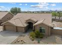 Charming single-story home featuring a well-manicured front yard with mature desert landscaping and a spacious driveway at 5005 E Baker Dr, Cave Creek, AZ 85331
