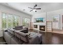Bright living room features a cozy fireplace, built-in bookshelves, large windows and plank flooring at 5005 E Baker Dr, Cave Creek, AZ 85331