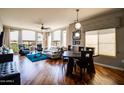 Open living space with large windows, hardwood flooring, a seating area, and a dining table at 5350 E Deer Valley Dr # 4239, Phoenix, AZ 85054