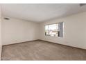 Comfortable bedroom with neutral carpet and a window, providing a bright and airy atmosphere at 5421 W Seldon Ln, Glendale, AZ 85302