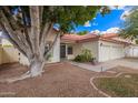 Inviting single-story home with a two-car garage, mature tree, and a well-manicured front yard at 5428 W Wethersfield Dr, Glendale, AZ 85304