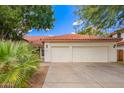 Charming single-story home with a two-car garage, beautiful desert landscaping, and a classic red tile roof at 5428 W Wethersfield Dr, Glendale, AZ 85304