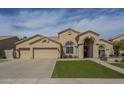 Inviting single-story home with a three-car garage and neatly maintained artificial turf lawn at 5900 W Orchid Ln, Chandler, AZ 85226