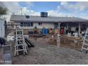Exterior view of the home's messy backyard at 610 E Estevan Ave, Apache Junction, AZ 85119