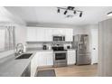 Modern kitchen features white cabinets, stainless steel appliances, and plenty of counter space at 672 S Porter St, Gilbert, AZ 85296
