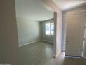 Bright living room with durable, light-toned tile flooring and a large window offering ample natural light at 7244 E Hackamore Ln, San Tan Valley, AZ 85143