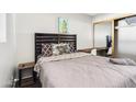 Cozy bedroom featuring a comfortable bed, stylish bedding, and a functional desk area with mirrored closet at 7520 E Papago Dr, Scottsdale, AZ 85257
