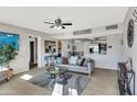 Bright and airy living room flowing into an open kitchen featuring a comfortable couch and stylish decor at 7520 E Papago Dr, Scottsdale, AZ 85257