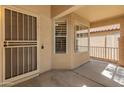Covered front porch with a security door and bright sunlight at 7916 W Mary Ann Dr, Peoria, AZ 85382