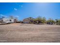 Single-story home featuring a well-kept yard, attached garage, mature landscaping, and an RV at 907 N Mountain Rd, Mesa, AZ 85207
