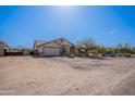 Lovely single-story home featuring a well-kept yard, attached garage, and mature landscaping at 907 N Mountain Rd, Mesa, AZ 85207