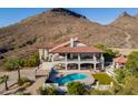 Stunning backyard featuring a refreshing pool, covered patio, desert views and an outdoor basketball court at 1234 E Claire Dr, Phoenix, AZ 85022