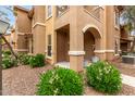 Charming condo exterior featuring a covered entry and well-maintained landscaping at 14250 W Wigwam Blvd # 2111, Litchfield Park, AZ 85340