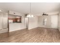 Spacious living room with open kitchen concept and modern wood-look flooring at 14250 W Wigwam Blvd # 2111, Litchfield Park, AZ 85340