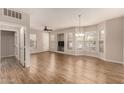 Bright living room with wood-look floors, neutral walls, and multiple windows at 14250 W Wigwam Blvd # 2111, Litchfield Park, AZ 85340