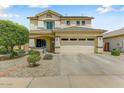 Inviting two-story home with a well-manicured front yard and a spacious two-car garage at 14554 W Evans Dr, Surprise, AZ 85379