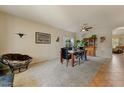 Open-concept living room featuring carpeted flooring, comfortable seating, and ample natural light at 14554 W Evans Dr, Surprise, AZ 85379