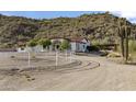 Extensive desert property with a beautiful home and a white fence outlining the perimeter of the property at 1500 N Crismon Rd, Mesa, AZ 85207