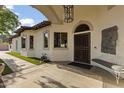 Aesthetic property with a ornate iron front door, tiled roof and an arched window above the entrance at 1500 N Crismon Rd, Mesa, AZ 85207