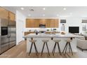 Spacious kitchen with a large island, stainless steel appliances, and ample cabinet space at 18141 W Hiddenview Dr, Goodyear, AZ 85338