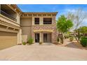 The home's exterior features a stone facade and desert landscaping on the property at 19700 N 76Th St # 2101, Scottsdale, AZ 85255