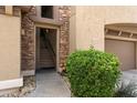 Inviting entryway with stone accents and a well-maintained bush near the unit's entrance at 19700 N 76Th St # 2169, Scottsdale, AZ 85255