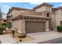 Charming two-story home featuring a two-car garage, desert landscaping, and a decorative stone facade at 19700 N 76Th St # 2169, Scottsdale, AZ 85255