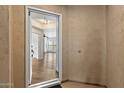 View of a bright foyer that leads to an open-plan living space and hardwood floors at 19700 N 76Th St # 2169, Scottsdale, AZ 85255