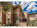 Side view showcasing a well-maintained stucco exterior and desert landscaping at 19777 N 76Th St # 1131, Scottsdale, AZ 85255