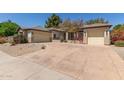 Charming single-story home featuring a circular driveway and desert landscaping with flowering bushes at 2060 E Prescott Pl, Chandler, AZ 85249
