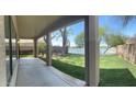 An outdoor patio providing a comfortable place to relax while offering picturesque views of the lake and backyard at 2074 N 109Th N Ave, Avondale, AZ 85392