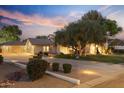 Expansive home exterior with circular driveway, mature trees, and charming curb appeal at 2106 E La Vieve Ln, Tempe, AZ 85284