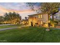 Stunning home exterior with mature landscaping, lush lawn, and a classic arched entrance at 2106 E La Vieve Ln, Tempe, AZ 85284