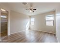 Bright, spacious bedroom with hardwood floors, ceiling fan, and natural light at 2220 N St Bonita Ln, Casa Grande, AZ 85122