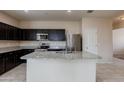 Modern kitchen featuring stainless steel appliances, granite countertops, and a central island at 2220 N St Bonita Ln, Casa Grande, AZ 85122