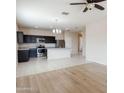 Open-concept kitchen with stainless appliances, granite counters, and an adjacent living space at 2220 N St Bonita Ln, Casa Grande, AZ 85122