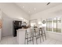 Well-lit kitchen featuring bar seating and modern appliances at 2309 W Shawnee Dr, Chandler, AZ 85224