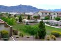 Picturesque neighborhood featuring lush landscaping, walking paths, and mountain views in the distance at 2348 W Alta Vista Rd, Phoenix, AZ 85041