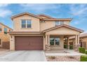 Two-story home boasting a large garage, covered porch, and well-maintained landscaping at 2425 E Flintlock Dr, Gilbert, AZ 85298