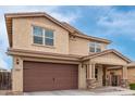 This two-story home features a large garage and a covered porch at 2425 E Flintlock Dr, Gilbert, AZ 85298