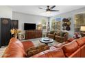 Bright living room featuring an orange leather sectional, wood cabinet, and neutral walls with decorative accents at 2425 W Bronco Butte Trl # 1056, Phoenix, AZ 85085