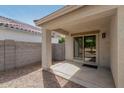 Covered back patio with sliding glass door and block wall for privacy at 2701 S Southwind Dr, Gilbert, AZ 85295