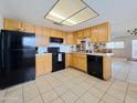 Functional kitchen with black appliances, and light wood cabinetry at 3108 W Butler Dr, Phoenix, AZ 85051
