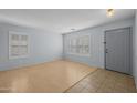 Bright living room featuring a hardwood floor, shuttered windows, and neutral paint at 3122 W Dunbar Dr, Phoenix, AZ 85041