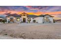 Beautiful modern home exterior featuring stone accents, desert landscaping, and a covered entryway at 35280 N Bell Rd, Queen Creek, AZ 85144