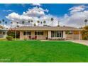 Charming single-story home with a well-manicured lawn and inviting covered porch at 4201 N 35Th St, Phoenix, AZ 85018